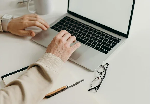 person typing on laptop keyboard