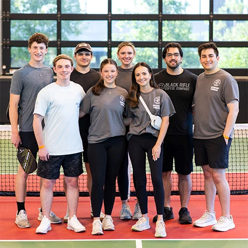 Klein Internship Program participants lined up on a pickle ball court